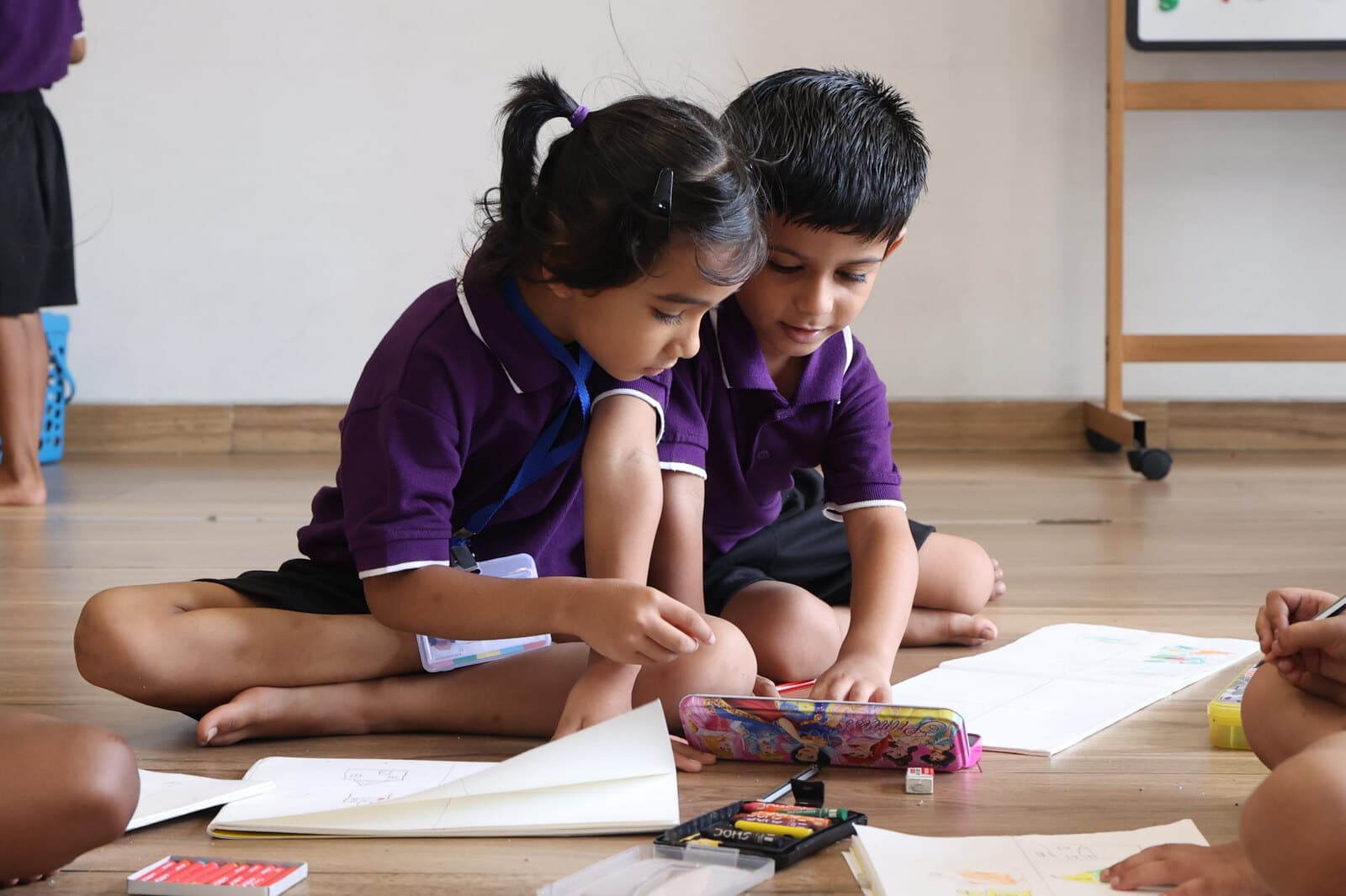 Young students collaborating on a drawing and design activity