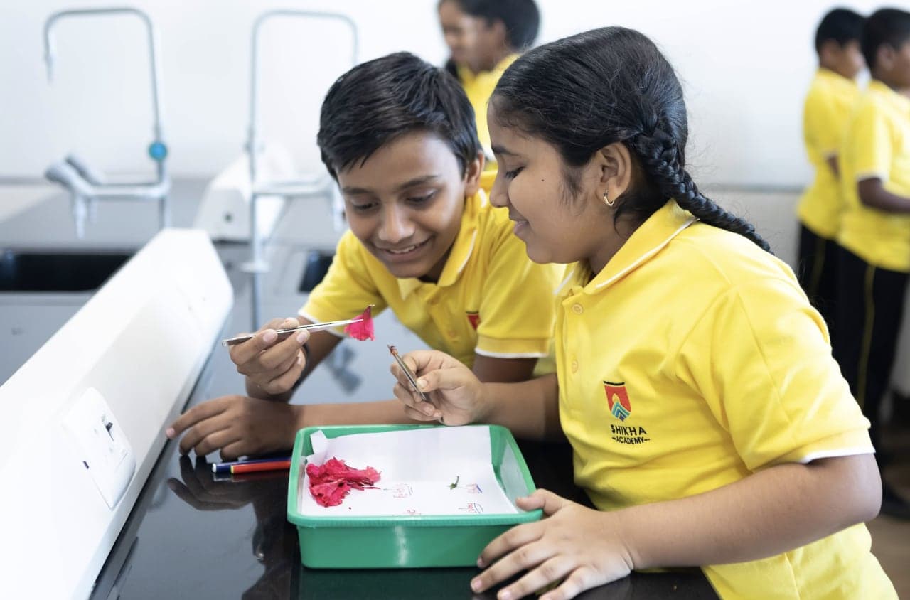 Two Shikha Academy students carrying out a hands-on science investigation